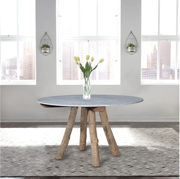 Bulli white marble top dining table on a grey rug in an apartment with large windows in the background.